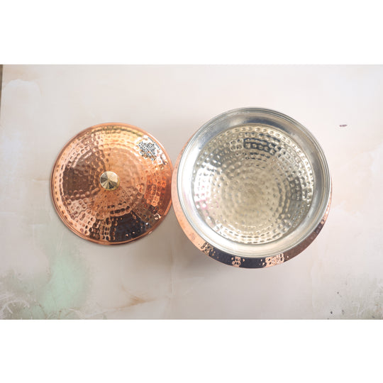 Ornate tamba handi with a sleek brass lid, designed for cooking and serving dishes with flair and functionality.