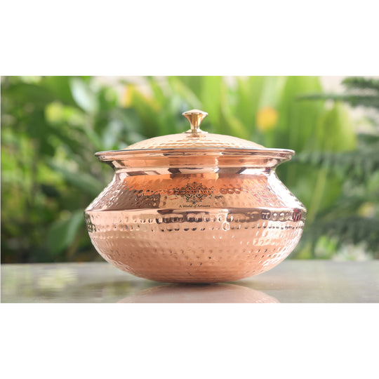 Traditional copper degchi with intricate hammered texture and a brass lid, designed for style and function by Indian Art Villa.