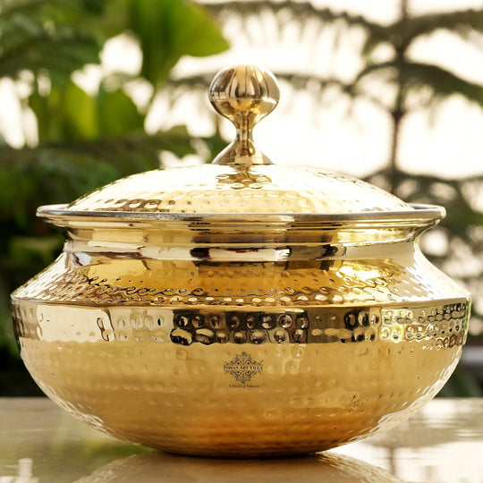 Decorative hammered brass handi vessel with golden finish rounded belly secure lid and inner tin lining for durability