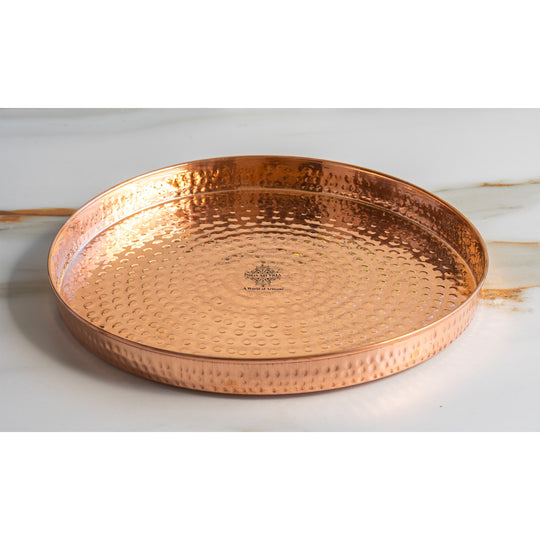 Elegant hammered copper thali perfect for presenting prasad during puja and religious events at home.