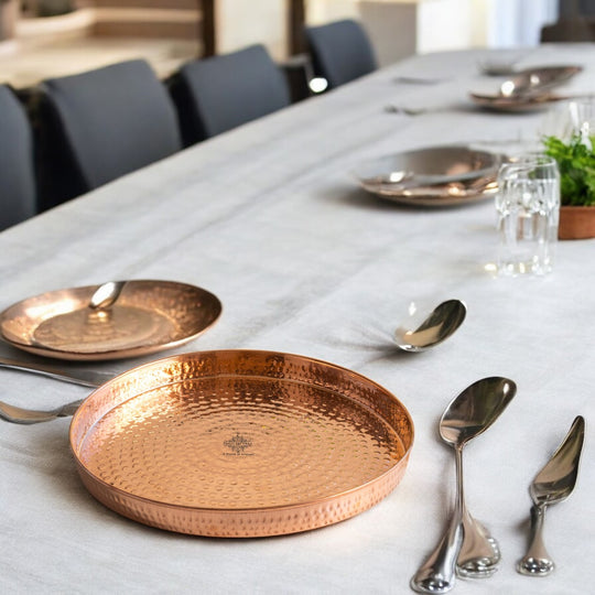 Authentic hammered copper thali perfect for serving food that enhances health during meals at the dining table.