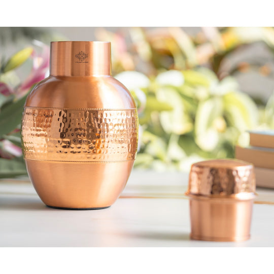 Copper bedroom water jar featuring a pot-inspired shape and hammered detailing