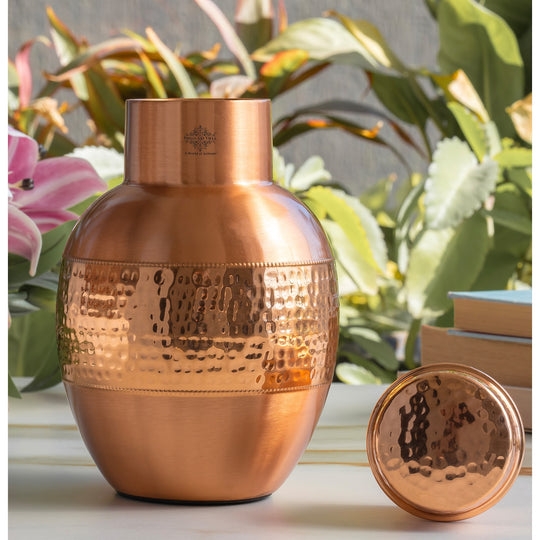 Lacquer finished copper bedside bottle with a partially hammered surface