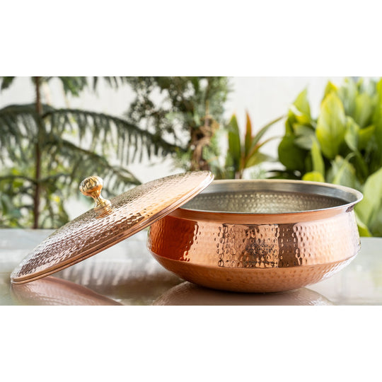 This copper handi from Indian Art Villa features tin lined interior and brass knob lid for traditional use