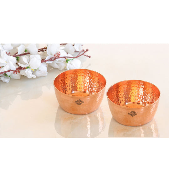 Stylish hammered copper bowl with a smooth texture and polished surface ideal for elegant displays.