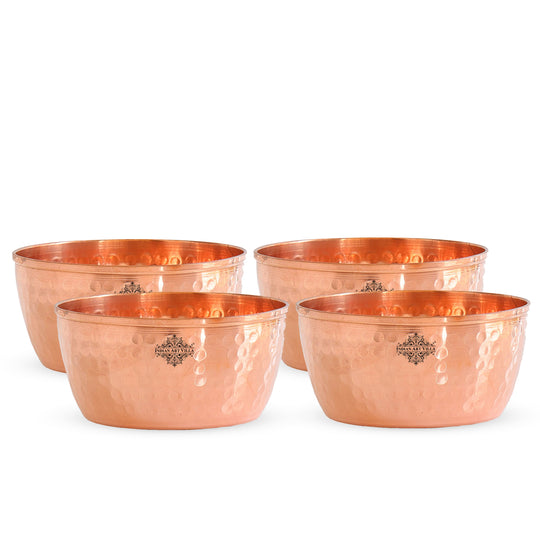 Classic hammered copper bowl set with a shiny reflective finish and beautiful texture for any occasion.