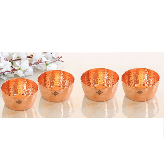 Gorgeous hammered copper bowl with set of 4 a sleek surface and unique pattern designed for serving or display.