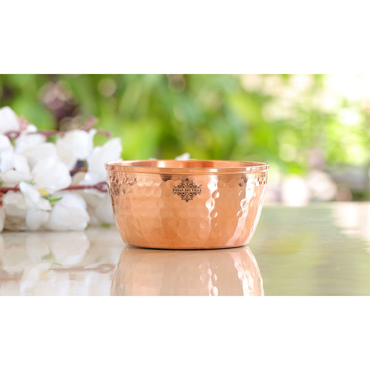 Beautiful hammered copper bowl with a smooth reflective surface and detailed texture ideal for any setting.