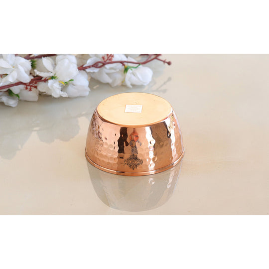 Elegant hammered copper bowl with a shiny finish and intricate textured design perfect for serving and decor.