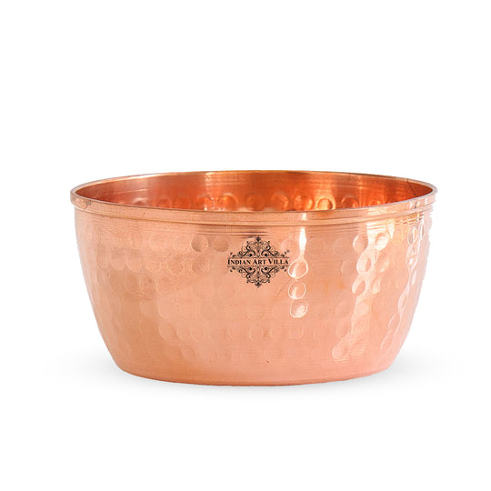 Handmade hammered copper bowl featuring a gleaming surface and textured design for stylish serving.
