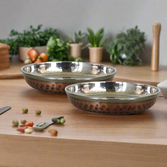 Decorative steel copper plate with hammered finish perfect for serving rice halwa and desserts at social events.
