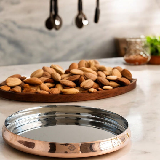 Traditional steel copper thali ideal for serving dishes at religious ceremonies family celebrations and festive meals.