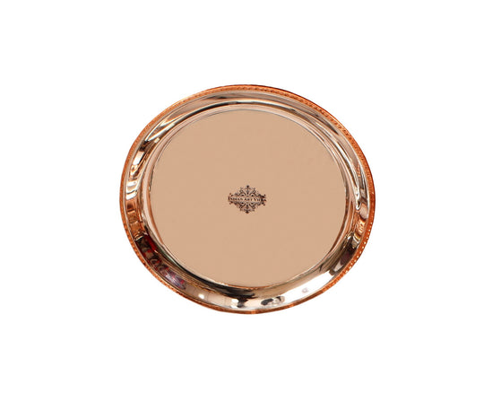 Indian art villa's copper thali with hammered texture and curved edges perfect for serving meals elegantly