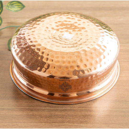 Handcrafted copper cookware pot with a stunning hammered finish, perfect for culinary and dining occasions.