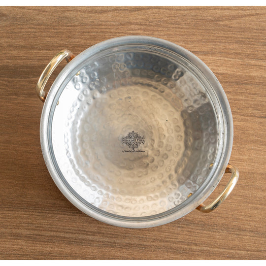 Stylish copper pot with hammered surface and tin coating, perfect for serving dishes or as home decor.