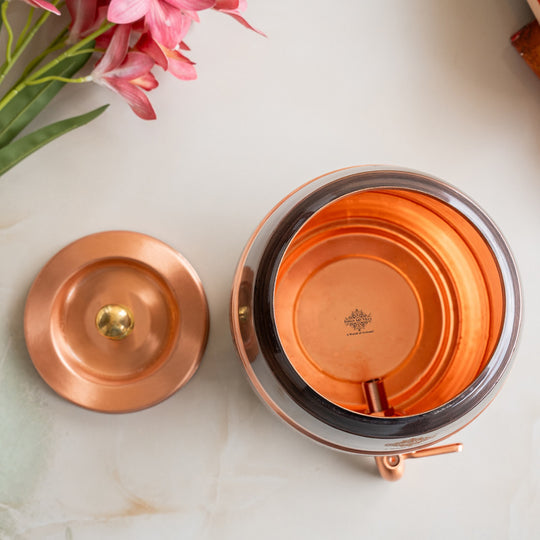 Angle of 5L printed copper matka on stand showing floral print body on iron legs – copper water pot with stand