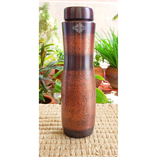 Detailed embossing wraps this Indian Art Villa copper bottle in antique dark elegance and charm.
