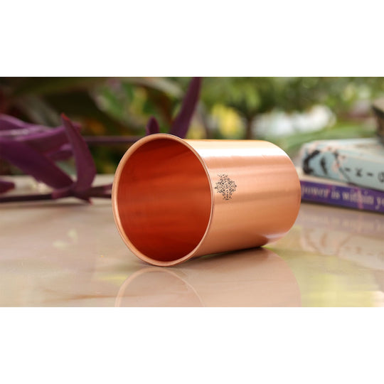 A beautiful copper jug, bottle, and glass set with a lacquered finish, perfect for any occasion.