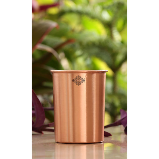 A beautiful copper jug, bottle, and glass set with a lacquered finish, perfect for any occasion.