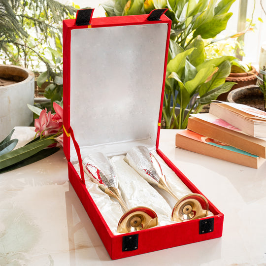 Decorative items in a red box with plants and books in the background