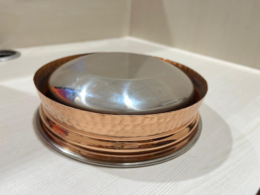 Add charm to your table with Indian Art Villa's hammered copper handi bowl featuring a smooth steel inner finish.