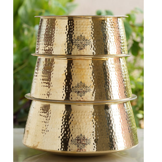 Durable brass cooking pot with polished golden body and tin lining used for preparing authentic Indian dishes during festivals