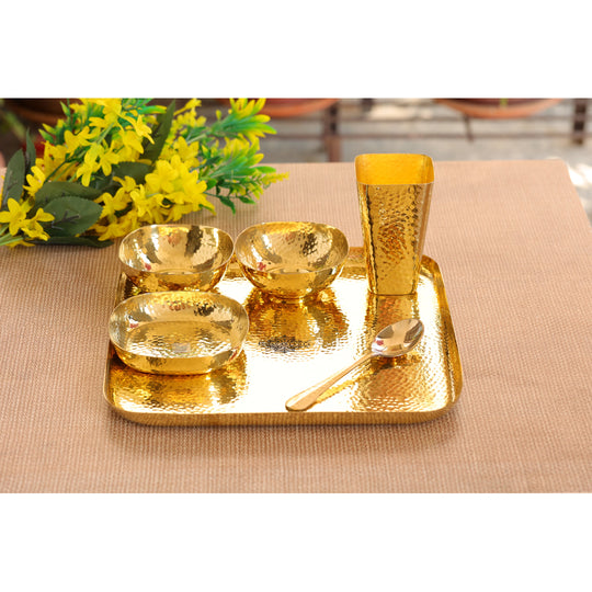 Indian Art Villa hammered brass dinner set with plate, bowls, glass, and spoon, perfect for traditional Indian dining.