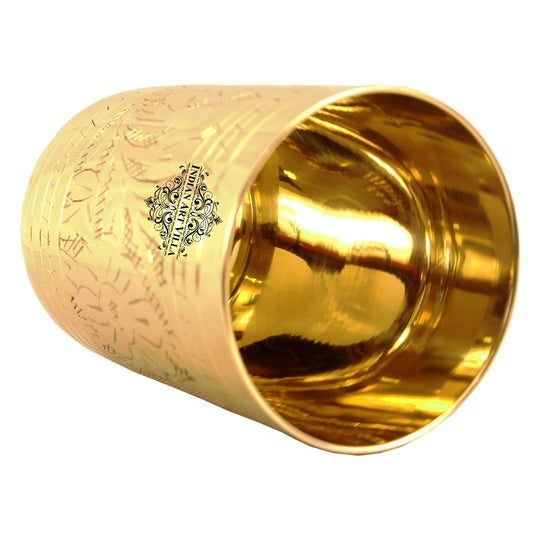 Intricate floral embossing on this brass glass makes it an ideal home decor item or a unique gift choice for your loved ones.