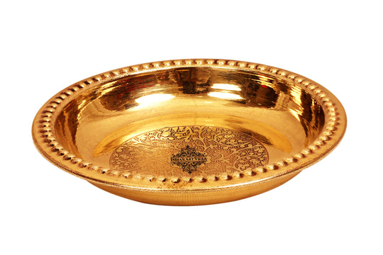 Round brass rice plate with engraved base and beaded outer rim crafted in smooth reflective golden tone