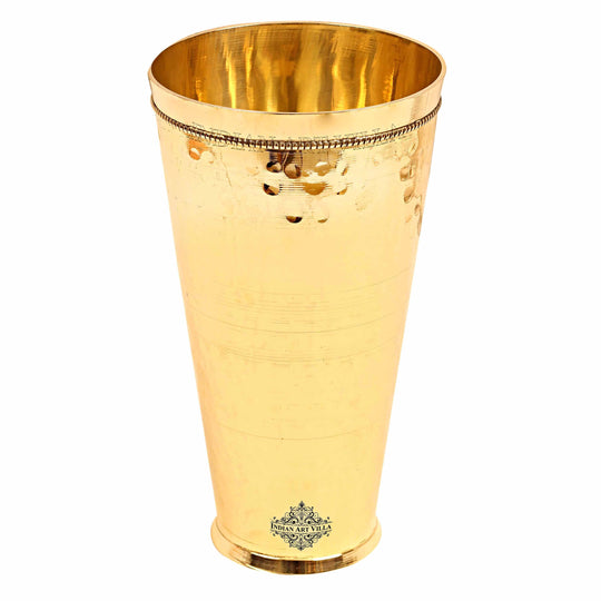 Traditional brass drinking glass with a sleek hammered design, perfect for enjoying lassi or other refreshing drinks.