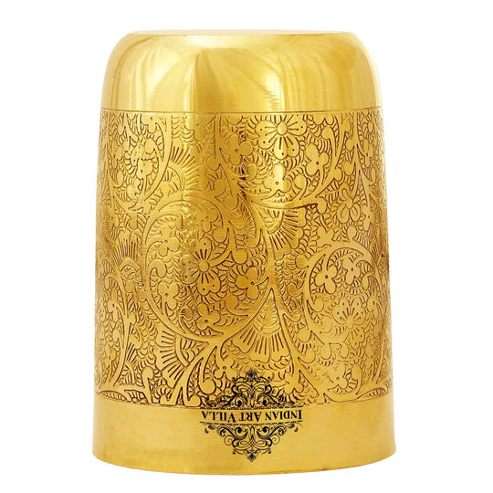 Curved brass tumbler with blooming vine motifs engraved by skilled artisans for a regal drinkware experience