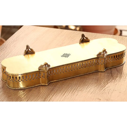 Long brass tray from Indian Art Villa featuring artisan sidework and curved edges with four ornamental raised legs