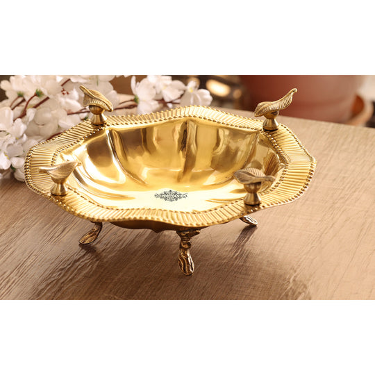 Decorative brass serving tray crafted in circular form with detailed leaf handles and glossy hand finished surface