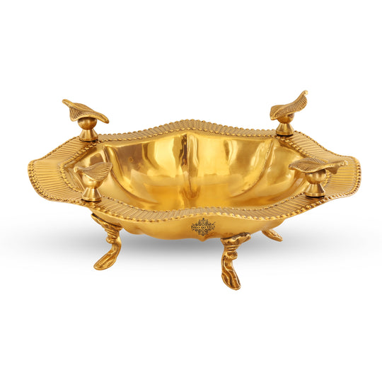 Pure brass serving tray with textured outer rim circular design and four detailed leaf shapes accenting the border