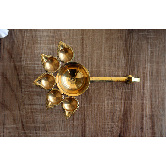 Brass aarti diya with deepak holders in a floral design, used for traditional Hindu rituals and puja ceremonies.