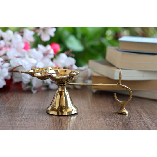 Brass aarti diya with deepak holders in a floral design, used for traditional Hindu rituals and puja ceremonies.