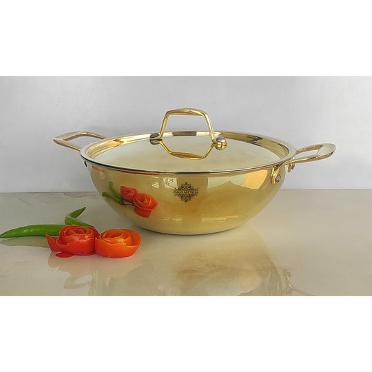 Round brass cookware piece with polished golden surface inner tin lining dual side handles and a fitted matching lid