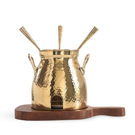 Polished hammered pital tandoor with three inserted skewers wooden support and curved dual side lifting handles