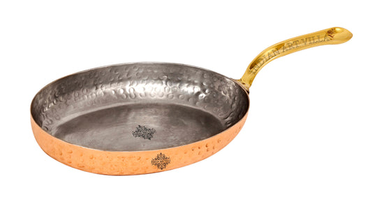 copper frying pan with brass handle and tin interior designed for efficient heat distribution by indian art villa.
