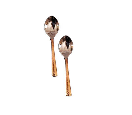 Stylish copper spoons with hammered copper handles and polished steel heads ideal for serving at dinner parties.