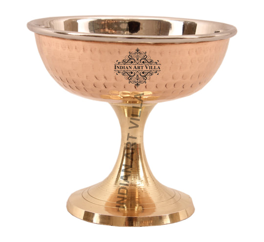 Polished copper bowl with a sleek brass pedestal perfect for serving treats adds an elegant flair to any dessert table.