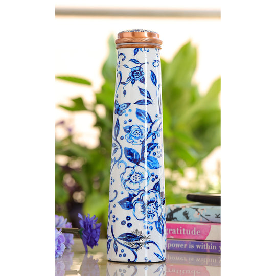 A bloom of wellness  Indian Art Villa 750ML copper metal water bottle, slim pyramid, dressed in elegant floral print.