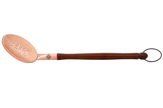 Copper serving spoon with wooden handle and ring perfect for serving meals in style at any dinner party