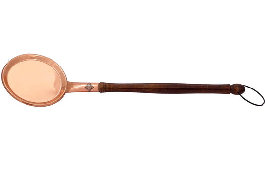 Premium copper spoon with a sturdy wooden handle ideal for draining and stirring food while cooking.