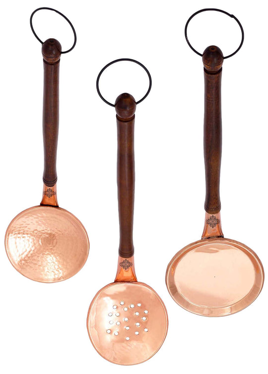 Stylish copper slotted spoon with an ergonomically designed wooden handle great for kitchen tasks and serving.