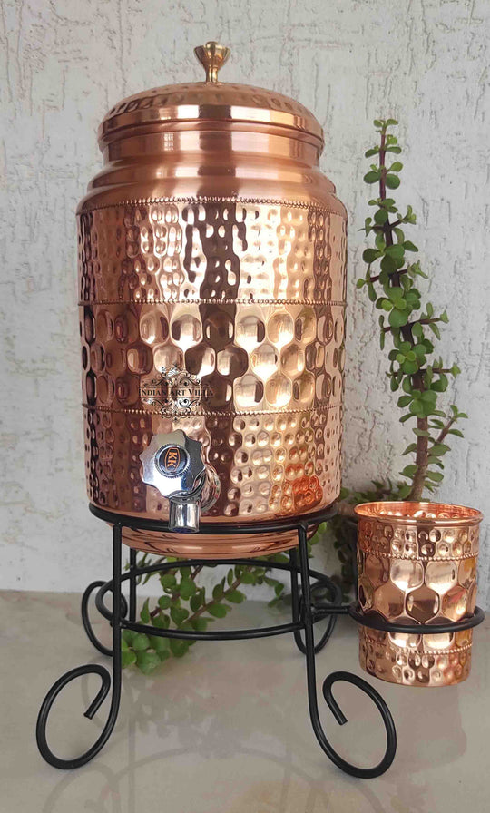 Angled view of round 5L copper matka on stand showing circular body raised on legs – copper water pot with stand