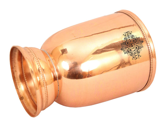 Beautifully crafted copper tumbler with polished shine and detailed base design, perfect for wine or decor.